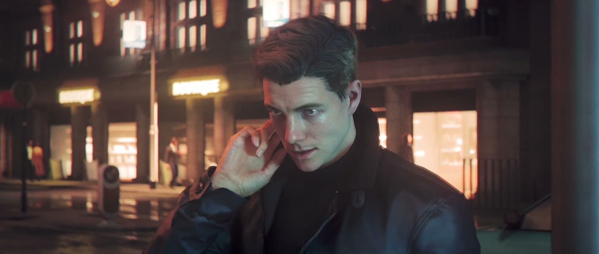 Official 007 First Light screenshot — a young James Bond takes a phone call on a rain-slicked city street at night, his face lit by storefront glow.