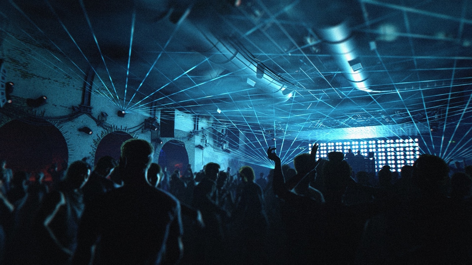 A packed nightclub dance floor under sweeping blue laser light with a glowing DJ stage in 007 First Light.