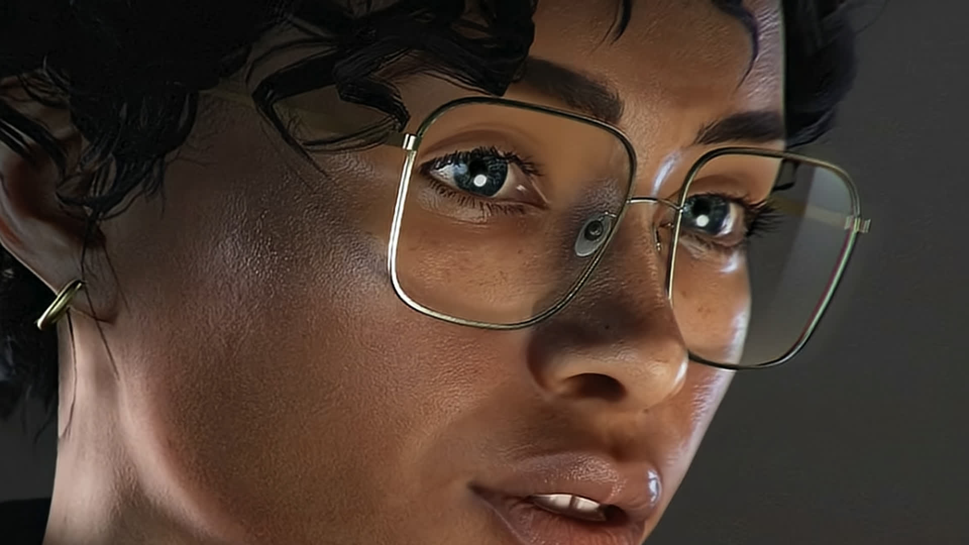 Official 007 First Light screenshot — an intent close-up of Moneypenny's eyes behind gold-rimmed glasses.
