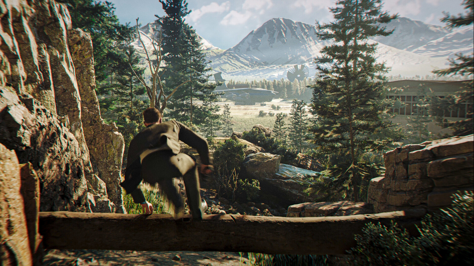 A figure clambering toward a forested mountain valley in 007 First Light.