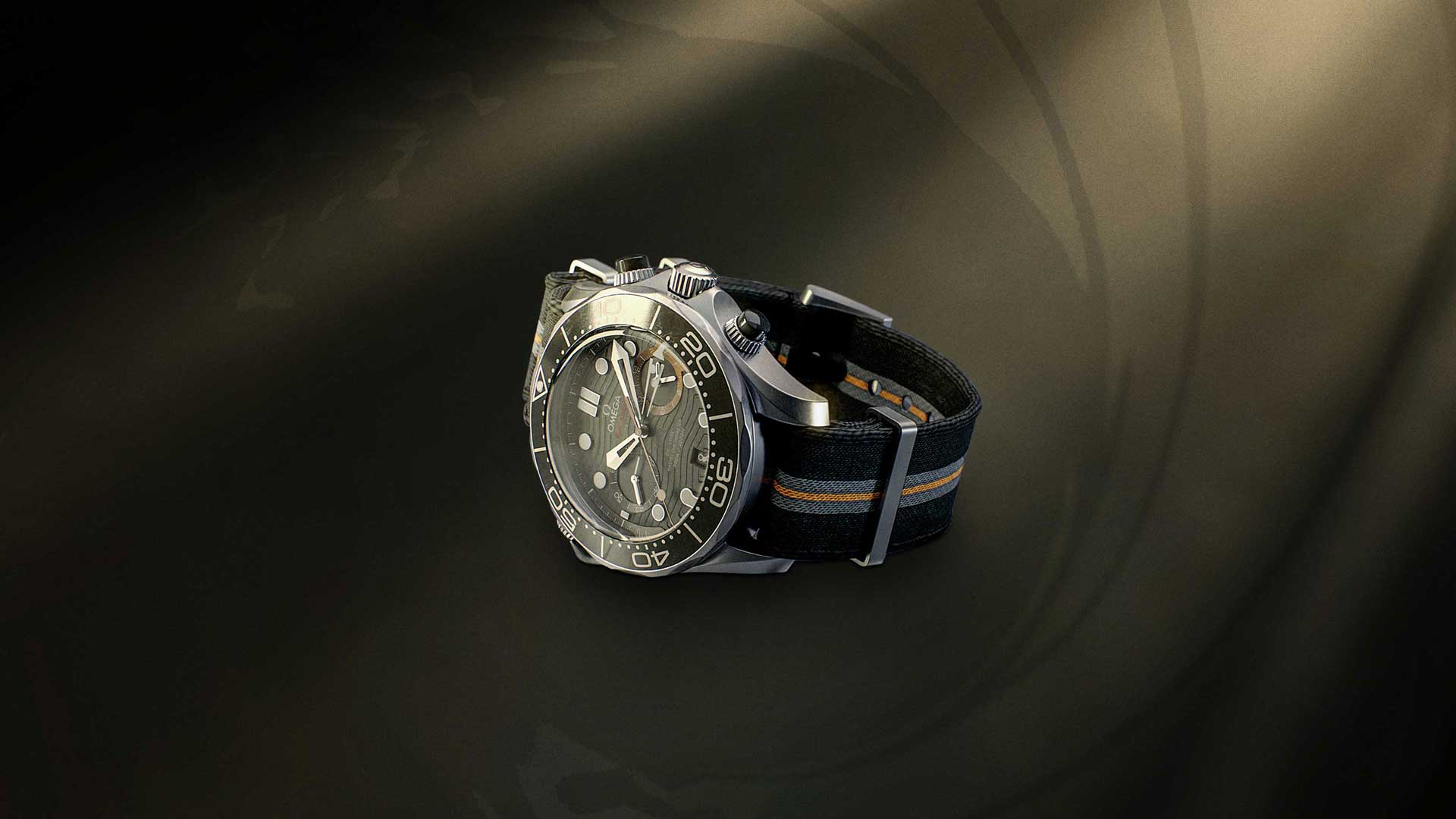Official 007 First Light render of the Q-Watch, an OMEGA chronograph on a striped NATO strap, on a gun-barrel backdrop.
